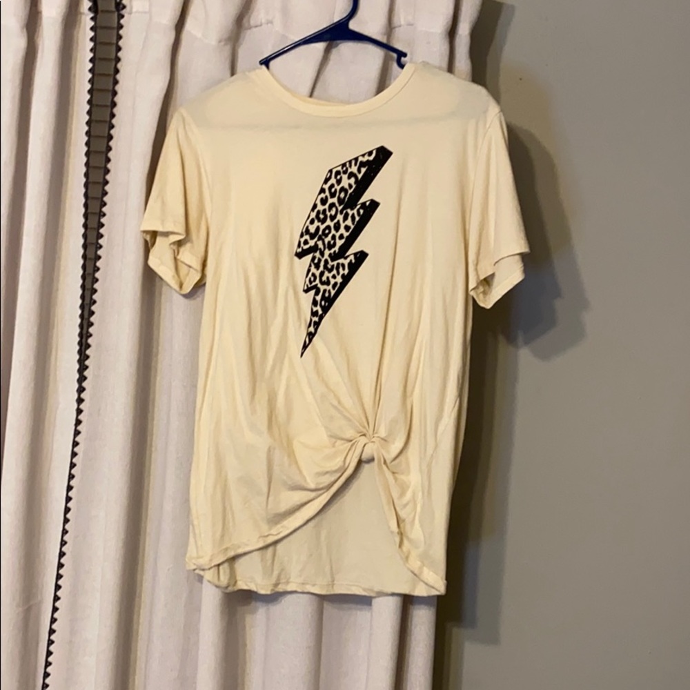 cream colored tshirt with a Lightning bolt on it